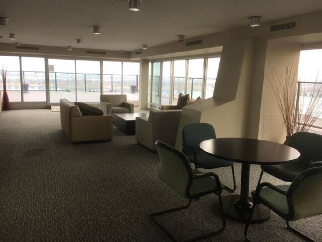 Another shared lounge, with a round table, chairs, and a fireplace.